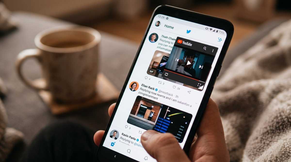 Android smartphone showing YouTube playing in a floating resizable bubble window over Twitter feed.